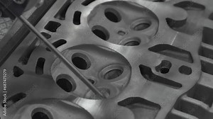 CMM machine measuring dimension at the valve position on the cylinder head parts . The quality control of automotive parts with multi axis CMM machine.