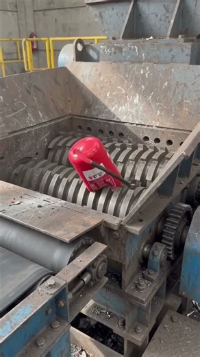 Show how to put a tank into a metal shredding machine and shred it from