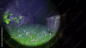 A man with a flashlight walks around the house in the dark at night. Creepy.