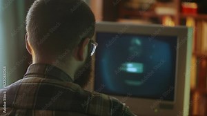 Geek programmer hacking password to breach data security system on vintage pc