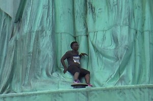Cops Descend on Liberty Island as Woman Scales Statue of Liberty During Protest