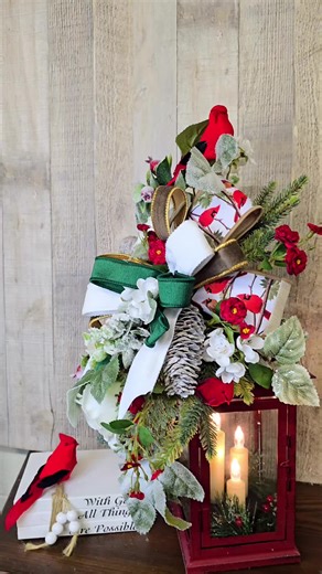 A little holiday magic in lantern form ✨🐦 Cozy glow, winter florals, and the sweetest cardinals. #HolidayDecor #ChristmasLantern #CardinalDecor #CozyChristmas #WinterDecor “Here’s a closer look at this holiday lantern arrangement — perfect for adding a warm glow to your Christmas décor. I used lush winter greenery, red blooms, snowy accents, and of course, the sweetest cardinals perched throughout. The LED candle flickers just like the real thing, making it beautiful for centerpieces, entryways