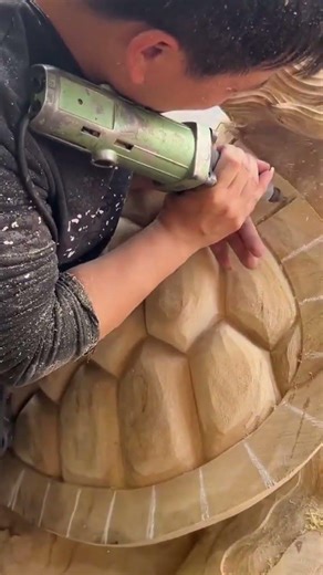 wood craftsman carves turtle shell patterns using drill machine
