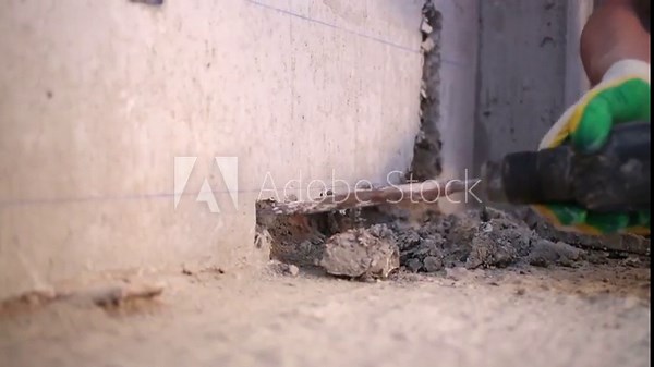 Making horizontal furrow in concrete wall using perforator.