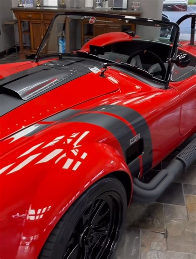 Shelby Cobra Backdraft de 1965, una réplica moderna del legendario Shelby Cobra original. Aquí hay información sobre este vehículo: Fabricante: Es una recreación construida por Backdraft Racing, que combina la herencia de las carreras vintage con ingeniería avanzada. Motorización: Generalmente, estas réplicas albergan un potente motor Ford V8, a menudo un 427ci, que ofrece una aceleración impresionante. Diseño: Presenta una carrocería ligera de fibra de vidrio, una postura agresiva, guardabarros