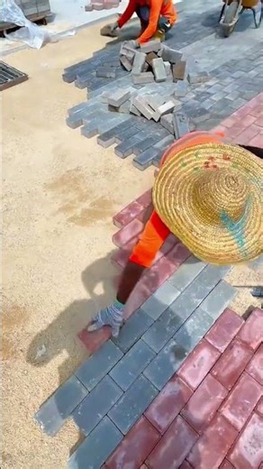 Worker Installing Interlocking Brick Pavers Creating Patterned Outdoor Walkway