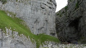 Gordale Scar ravine with two waterfalls in North Yorkshire, England.Beautiful views and limestone cliffs attract people for different outdoor activities like rock climbing, walking, trekking etc