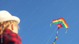 child kid launches a kite. happy childhood kid dream concept. little girl playing with a kite in the park. kite flying in the sky. travel outside fun nature concept