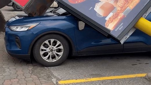 Tim Hortons Sign Snaps and Crushes Car During Wind Advisory