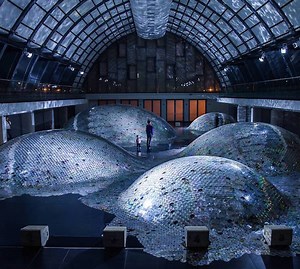 Artist Uses 60,000 Compact Discs to Create a Shimmering Metallic Ocean Inside a Warehouse