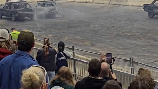See demo derby car break through safety barrier, crash into crowd
