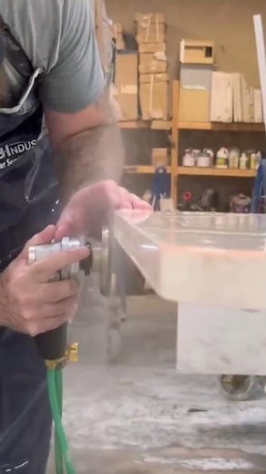 smoothing the sharp edges on the stone table surface