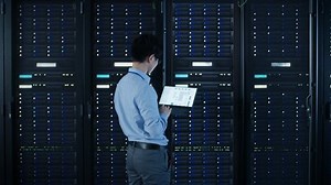 clip-1022590747-modern-data-center-engineer-standing-beside-open