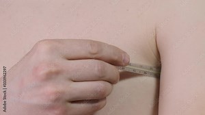 Man measures the temperature with a thermometer. Close up.