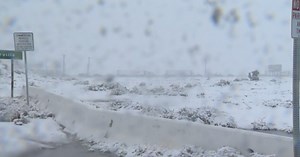 Dangerous driving conditions as snow falls in Cajon Pass