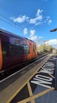 Ritchie catching a glimpse of a West Midlands Railway class 196 at Barnt Green