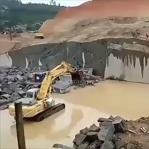Excavator pulling a slab out