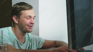 Man sitting at desk looking at computer screen, communicating via internet. concept of online dating. 4k, slow motion