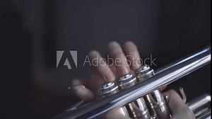 Fingers of a trumpet player playing a silver plated trumpet on the valves in slow motion Stock Video