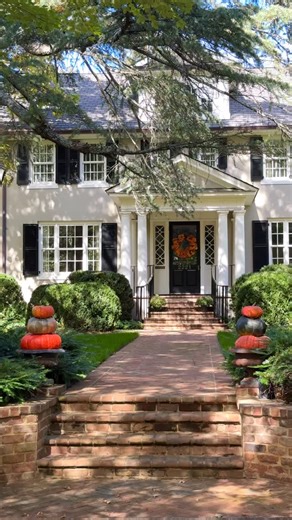 Garden & Grace | Home Design Guide on Instagram: "An effortless fall curb-appeal 🧡🤎💛 …. Classic architecture, boxwoods, brick pavers, pumpkin decor, Charlotte, old homes, Southern design"