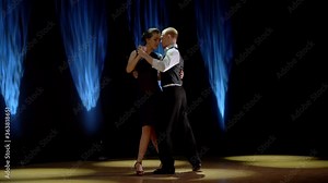A man and a woman dancing tango. Beautiful light, professional dancers.