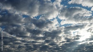 Altocumulus, middle-altitude cloud genus, stratocumuliform physical category, characterized by globular masses or rolls in layers or patches being larger and darker. Airmass instability. Real time.
