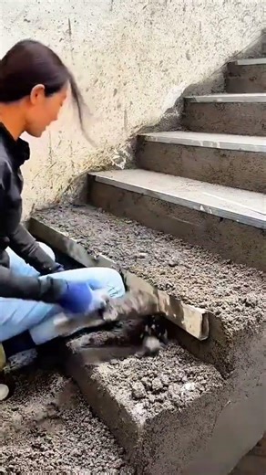 leveling concrete mixture to create smooth outdoor stairs using professional masonry tools at home