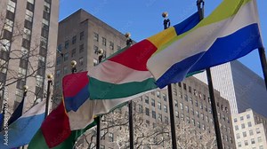 International flags from around the world. Pan of flags blowing in wind.