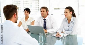 Smiling interview panel talking to applicant