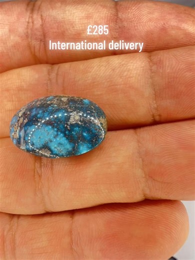 22.2 CT Midnight Blue Persian Turquoise Cabochon This natural 22.2 CT Persian Turquoise is a rare find, boasting a remarkably deep cobalt and indigo saturation. The gemstone is characterized by a heavy pewter-toned metallic matrix that swirls through the rich blue, creating a dramatic, starry-night effect. Expertly polished to a high-gloss sheen, this opaque oval stone features a dense, velvety color profile that contrasts beautifully against silver or white gold. Whether utilized for a bold sta