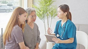 Asian doctor woman visited patient elder woman to diagnosis and check up health at home or private hospital. Female patient looking Medical Checkup Course for elderly health care at premium clinic.