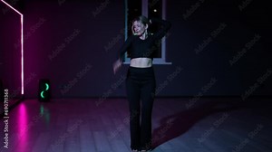 Live camera. Dancing woman in a dark choreographic hall with neon lighting. Expressive, active dance Waacking Stock Video
