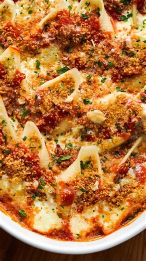 Tasty on Instagram: "These giant cheese-stuffed shells are a cheesy dream, not just an Olive Garden fantasy. 🧀✨ Pasta goals: jumbo shells filled with four-cheese magic, drenched in marinara and alfredo, with a crispy breadcrumb finish. Bookmark this one! 🍝 Find the recipe linked in bio @whisperofyum"