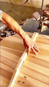 Woodworker Gluing A Wooden Rod Or Batten Onto Large Wood Panel