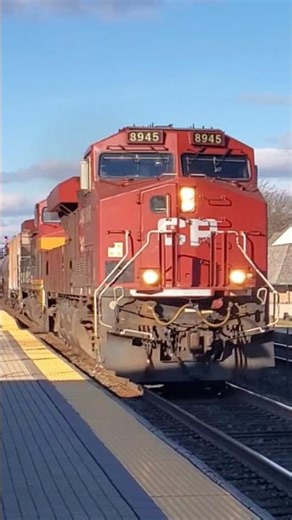 CP 8945 leads a tanker train past Lake Forest