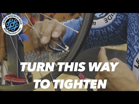 Turn the spoke wrench this direction to tighten.