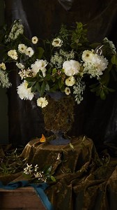 Drawing inspiration from the Dutch master Otto Marseus van Schrieck, these lofty peonies and mountain laurels emerge from a classic vase, its surface adorned with a tapestry of moss. See more floral arrangements that celebrate sottobosco, at the link in our bio. — Photography by Becky Luigart-Stayner (@sunnyhousestudio) Produced by Sara Clark (@saraellisclark) and Katie Hinson (@hatie_kinson) | Veranda Magazine