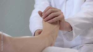 Physician examining patient sprained leg, first aid in trauma clinic, closeup
