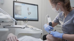 Orthodontist using 3D intraoral scanner for scanning teeth patient's. Modern dental clinic with equipment. Dentistry and health care concept. Jaw scan, digital imprint, medical digital technology.