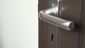 clip-30200815-hand-inserting-key-into-keyhole-opening-unlocking