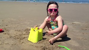 Little Girl Making A Sand Castle