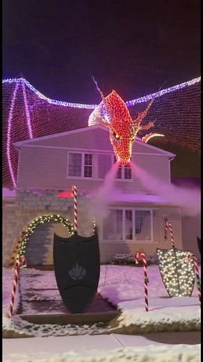 This might be the most insane yard display I’ve ever seen. A full-on CHRISTMAS DRAGON perched on the roof! Who’s battling this in their holiday party? 🐉✨ Comment if you’d want this in your yard! | Tales That Shouldn’t Be Told