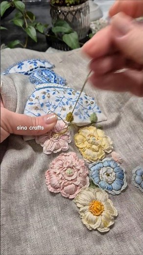 Story of blue - stitching an imperial blue vase with blooming rococo flowers on rustic canvas.