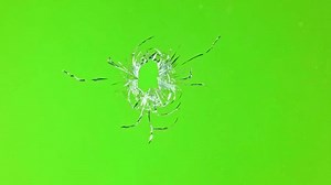 Super slow motion of gunshot through the glass, shattering against green screen background . Filmed on high speed cinema camera, 1000 fps.