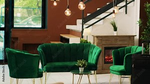 Hotel lobby with empty lounge area and reception desk, decorations and classy interior design. Resort entrance decorated with plants and marble floors, stylish furniture and couch.