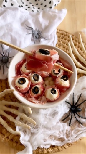 👁️ These Halloween Mozza Eyes are delightfully eerie and a must-make! Creamy mozzarella, black olives, and prosciutto for the spookiest appetizer ever! 🎃✨ They're hauntingly delicious! https://homemadeheather.com/halloween-mozza-eyes-appetizer/ | Homemade Heather