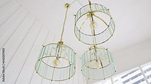 a chandelier hangs elegantly, illuminating the space with its radiant glow. The intricate design and shimmering crystals create a captivating display of opulence and ambiance. High quality 4k footage
