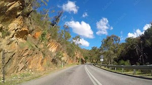 Driving along Gorge Road, The Gorge Scenic Drive, Adelaide Hills, South Australia, on a sunny afternoon, with lens flare, vehicle POV. 4K time lapse.