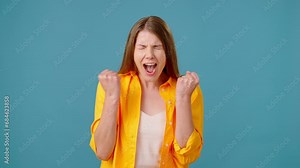 Furious woman shouts and tightens fists in angry outburst