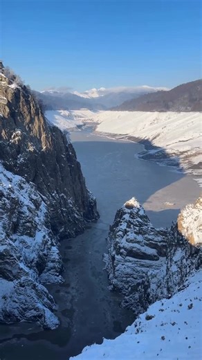 Romania on Instagram: "Does emptiness scare you? Winter at Vidraru Dam feels like a set abandoned by the gods mid-scene, the lake bled dry, the valley exposed like a ribcage. This isn’t absence, it’s revelation. Romania, when it drops the folklore costumes and shows you the machinery underneath, raw, severe, almost blasphemous in its honesty. The dam rises 166 meters of poured defiance, completed in 1965 after years of tunneling, blasting, and quiet heroics that cost dozens of lives. When engine